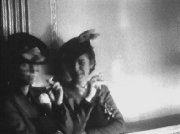 Film Society mavens Dorothy Fowler and Moira Armour light up in the Stanley Theatre lobby during intermission, April 14, 1940.